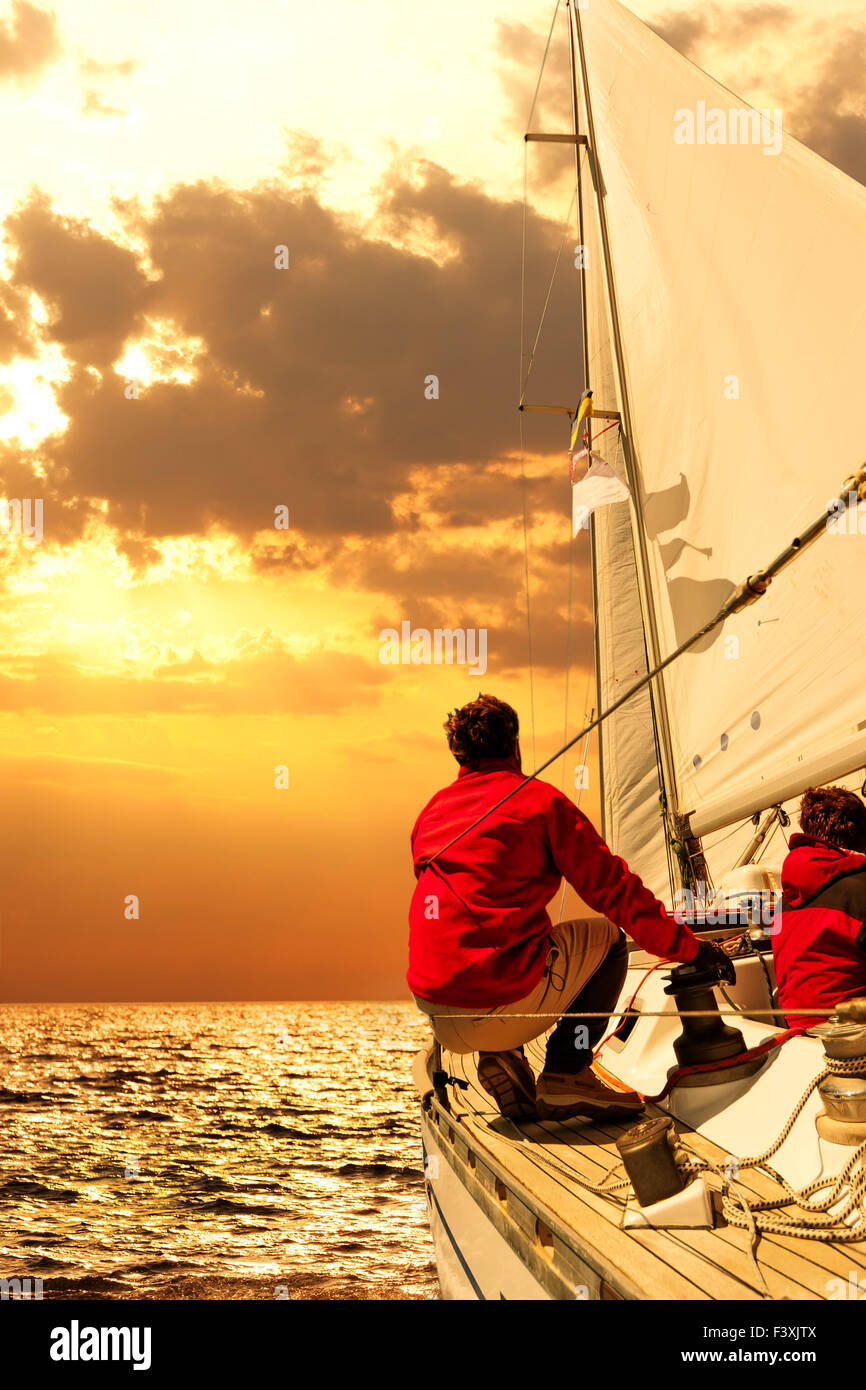 Silhouette people boat in sea sky sunset boat hi-res stock photography