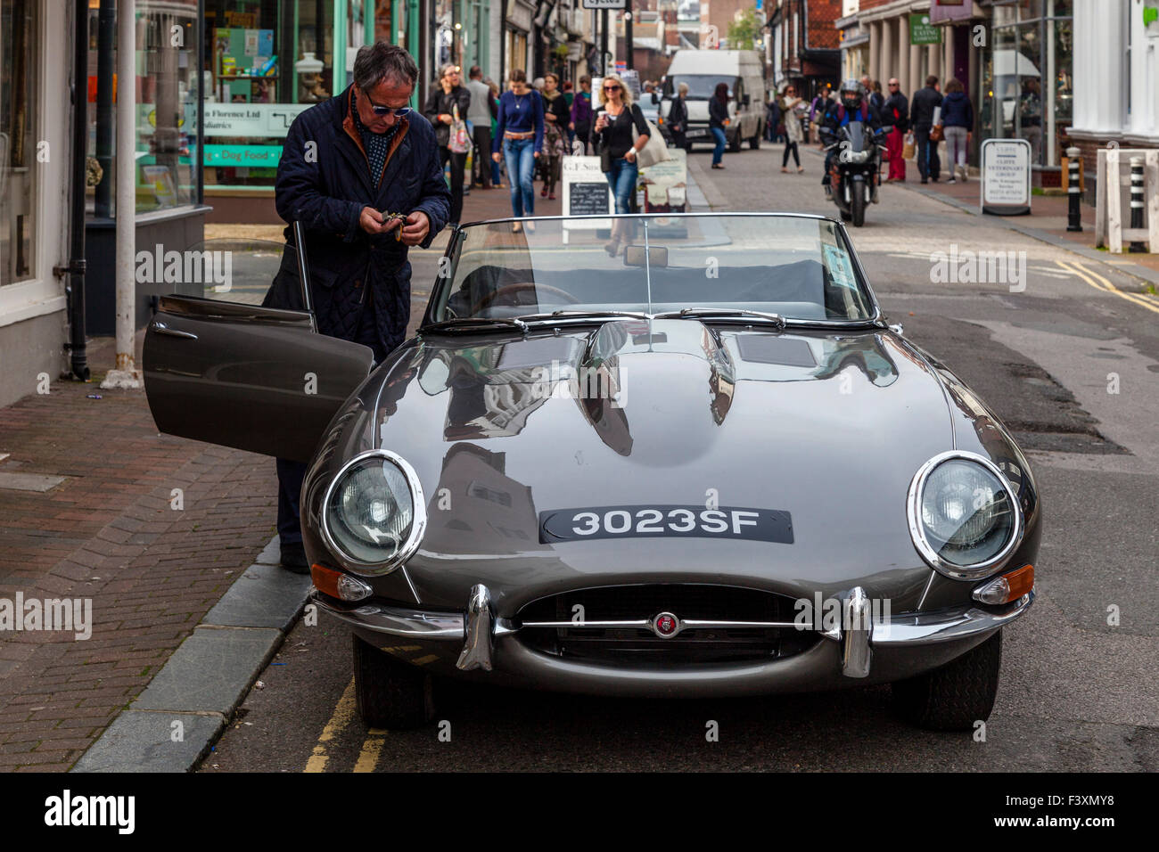 A Man Getting Into His Sports Car, High Street, Lewes, Sussex, UK Stock Photo