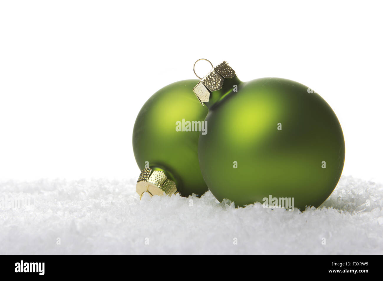 green christmas balls on artificial snow Stock Photo