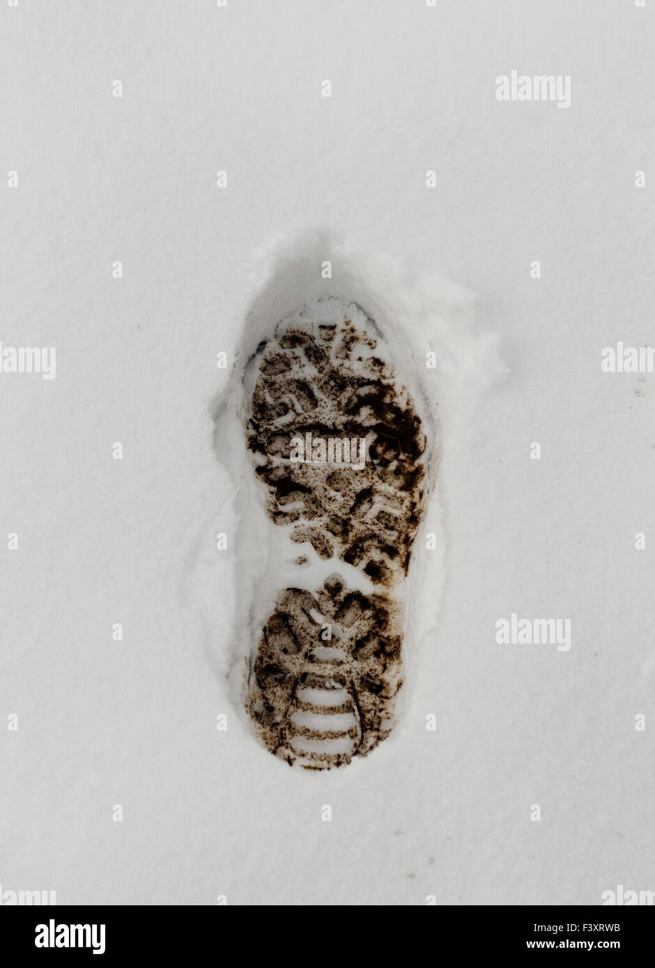 Muddy Footprint in the fresh white snow Stock Photo