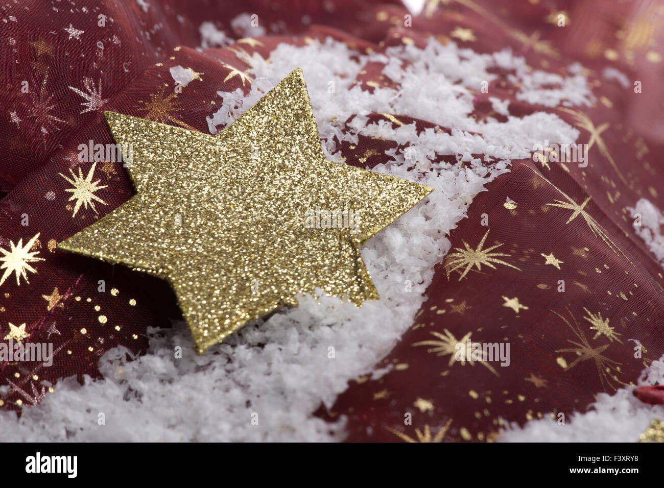 golden christmas star on artificial snow Stock Photo