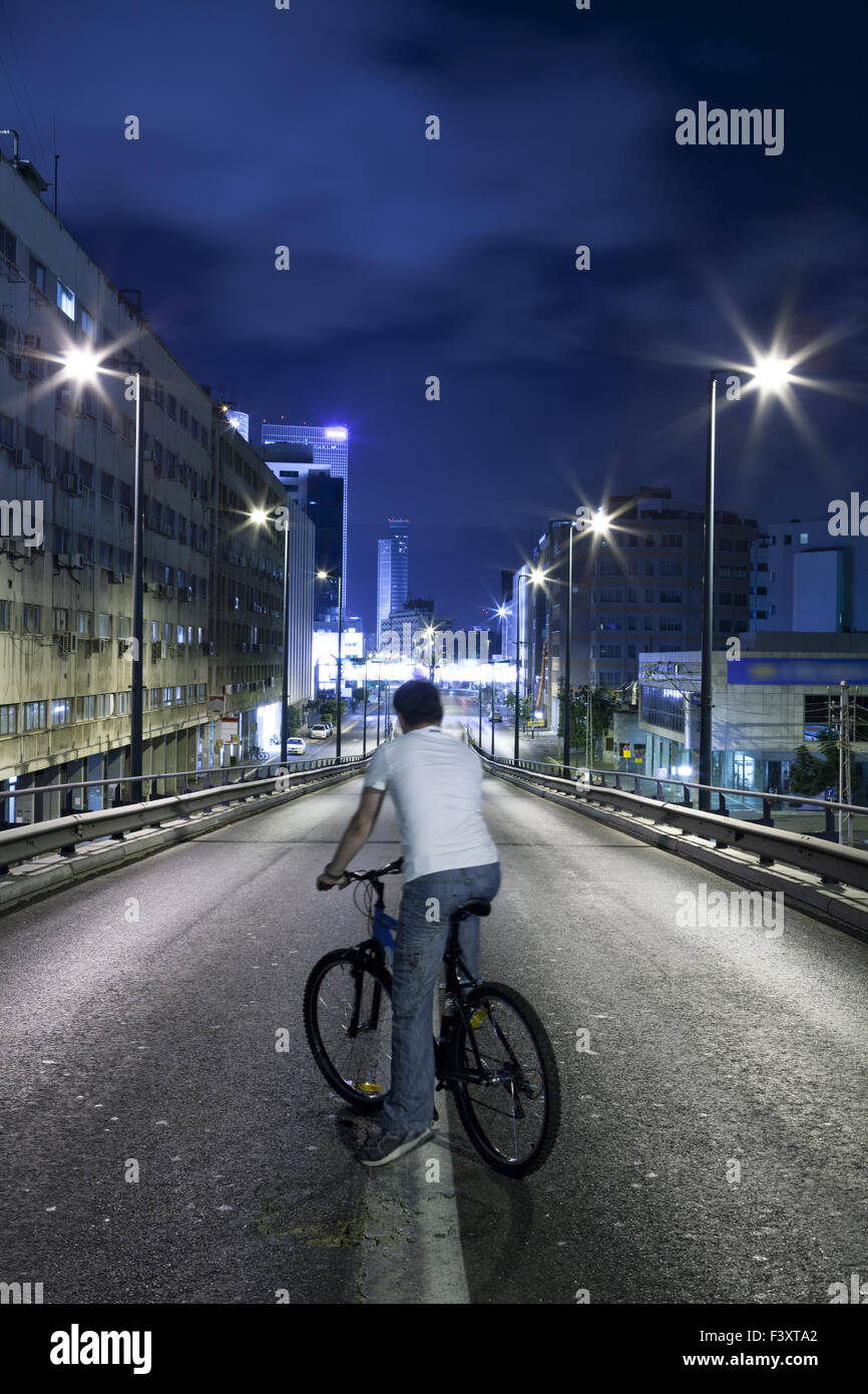 Men on a Bicycle on Empty Way Stock Photo