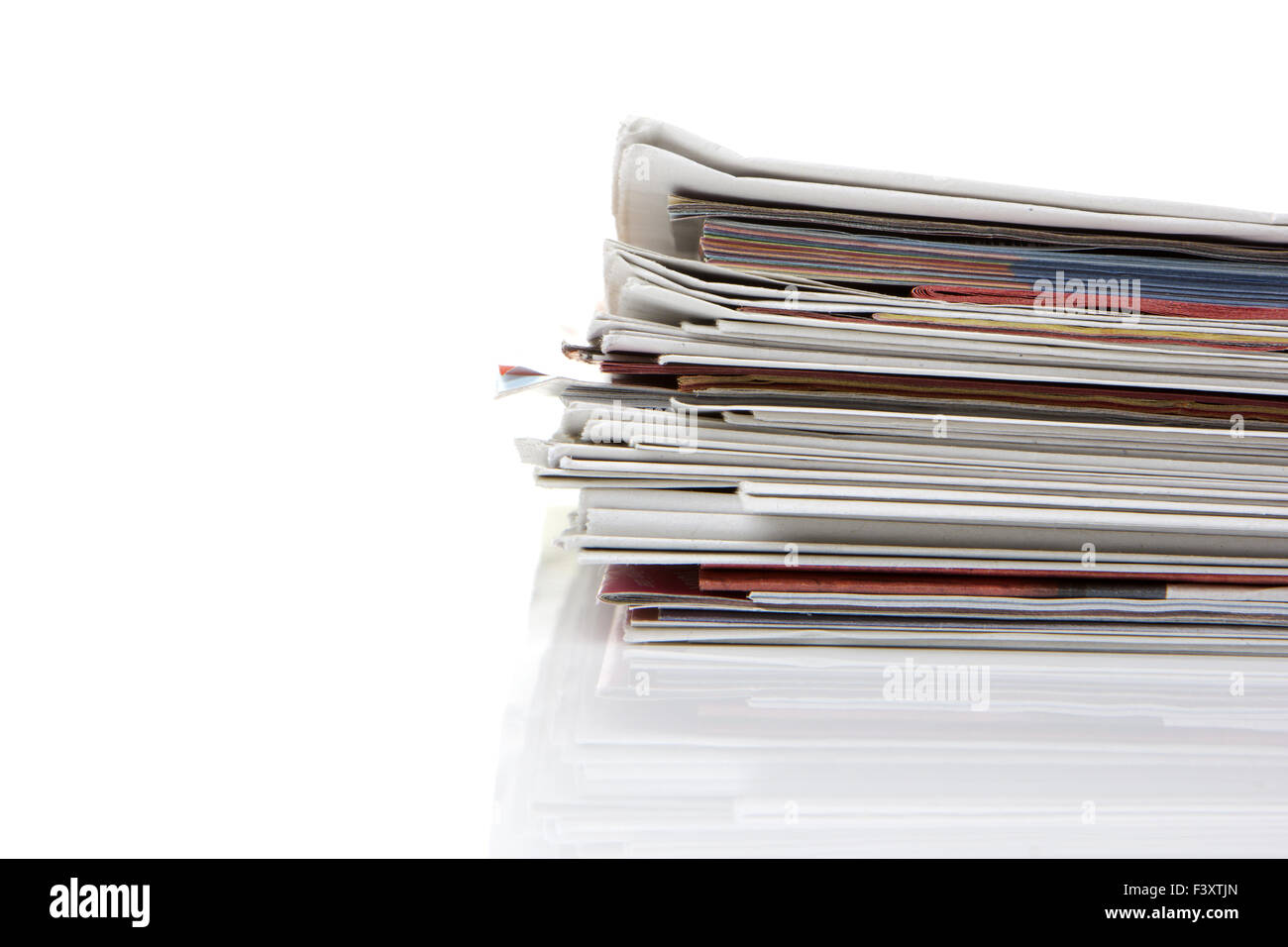 several newspapers, journals stacked on white Stock Photo