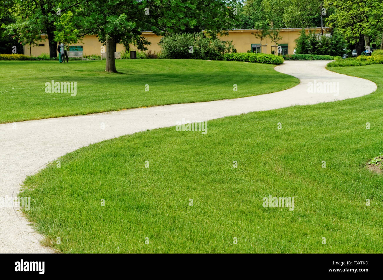 Winding path through a peaceful green garden Stock Photo