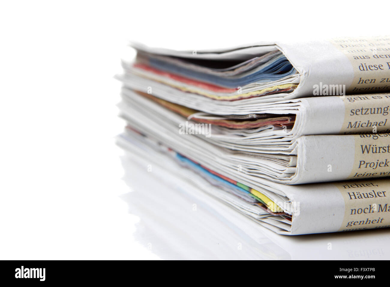 several newspapers, journals stacked on white Stock Photo