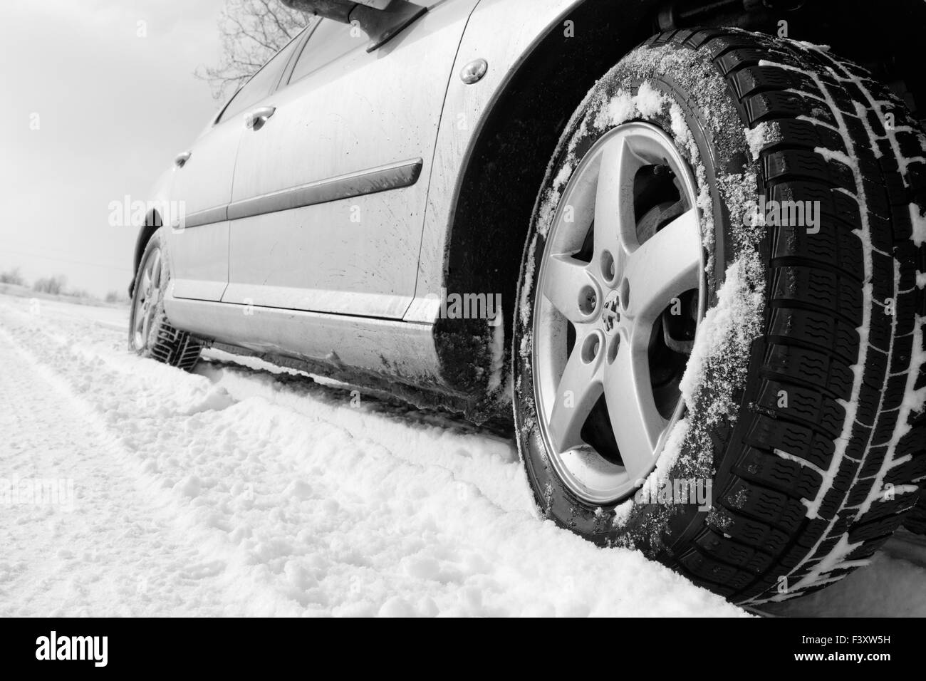 Close up of a cars tires on a snowy road Stock Photo