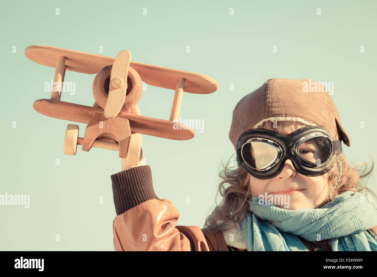 Happy kid playing with toy airplane Stock Photo - Alamy