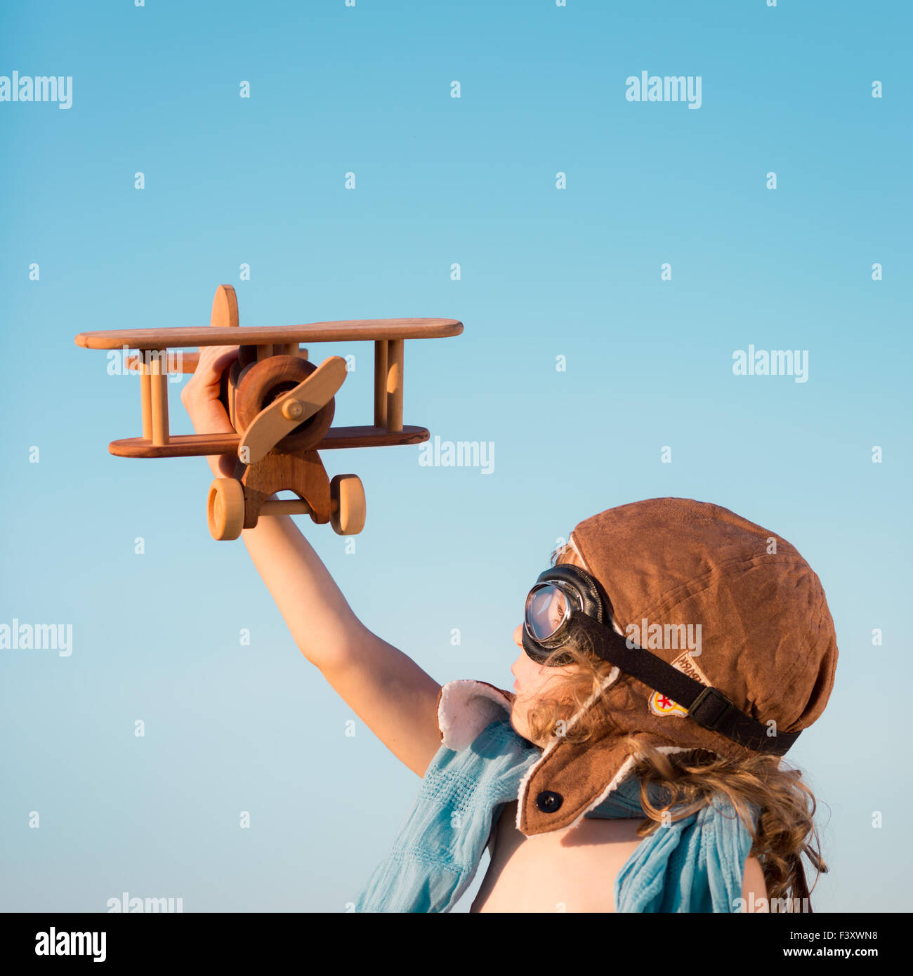 Happy kid playing with toy airplane Stock Photo - Alamy