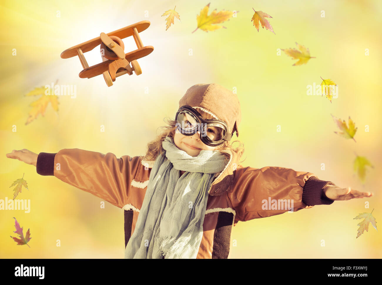 Happy kid playing with toy airplane Stock Photo - Alamy