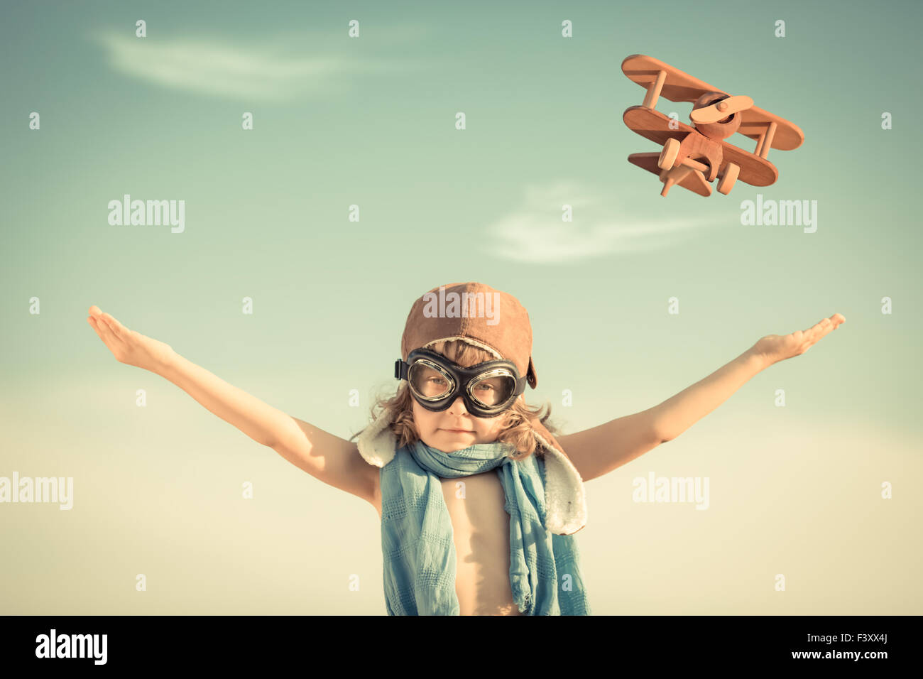 Happy kid playing with toy airplane Stock Photo - Alamy