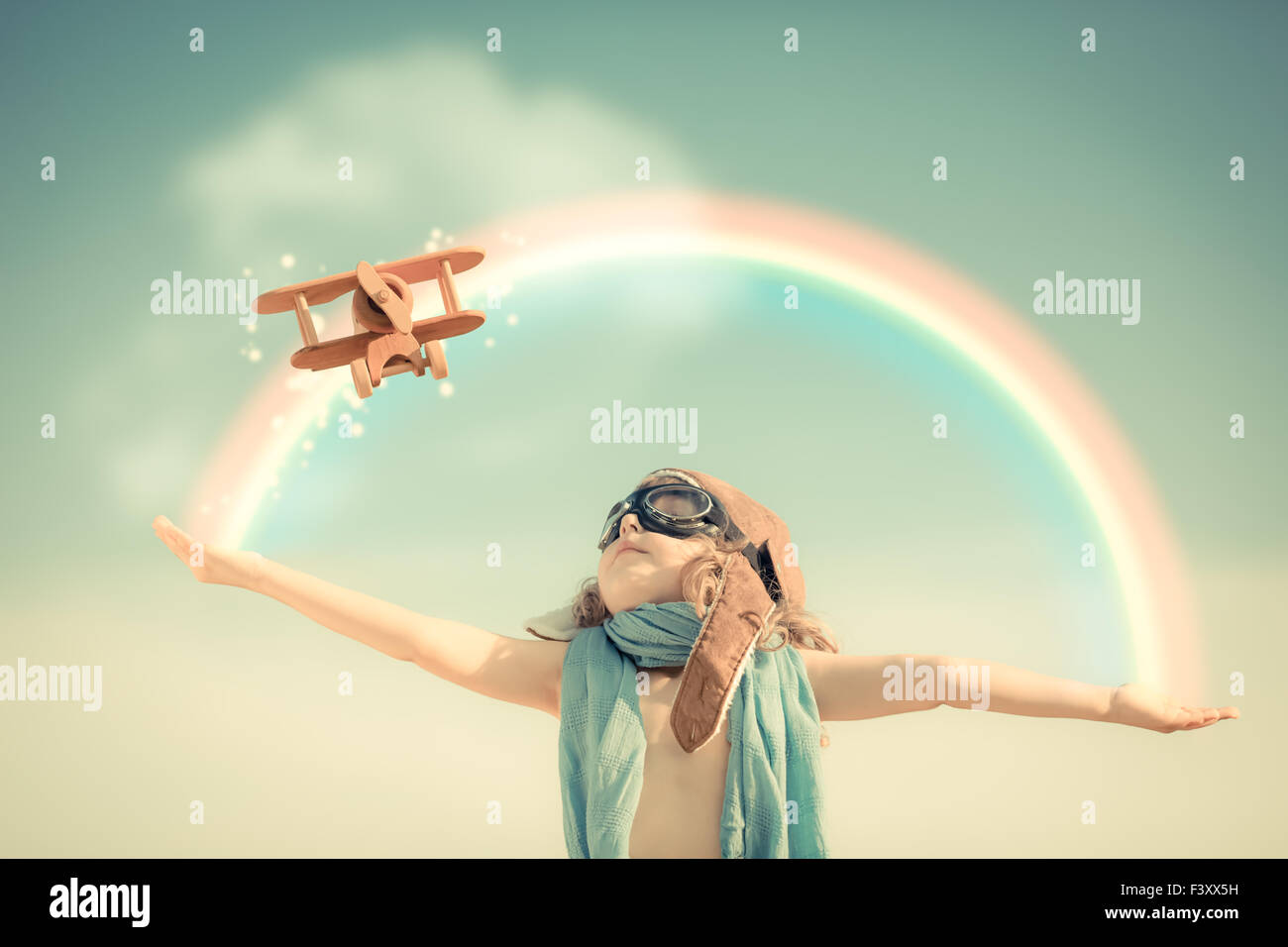 Happy kid playing with toy airplane Stock Photo - Alamy