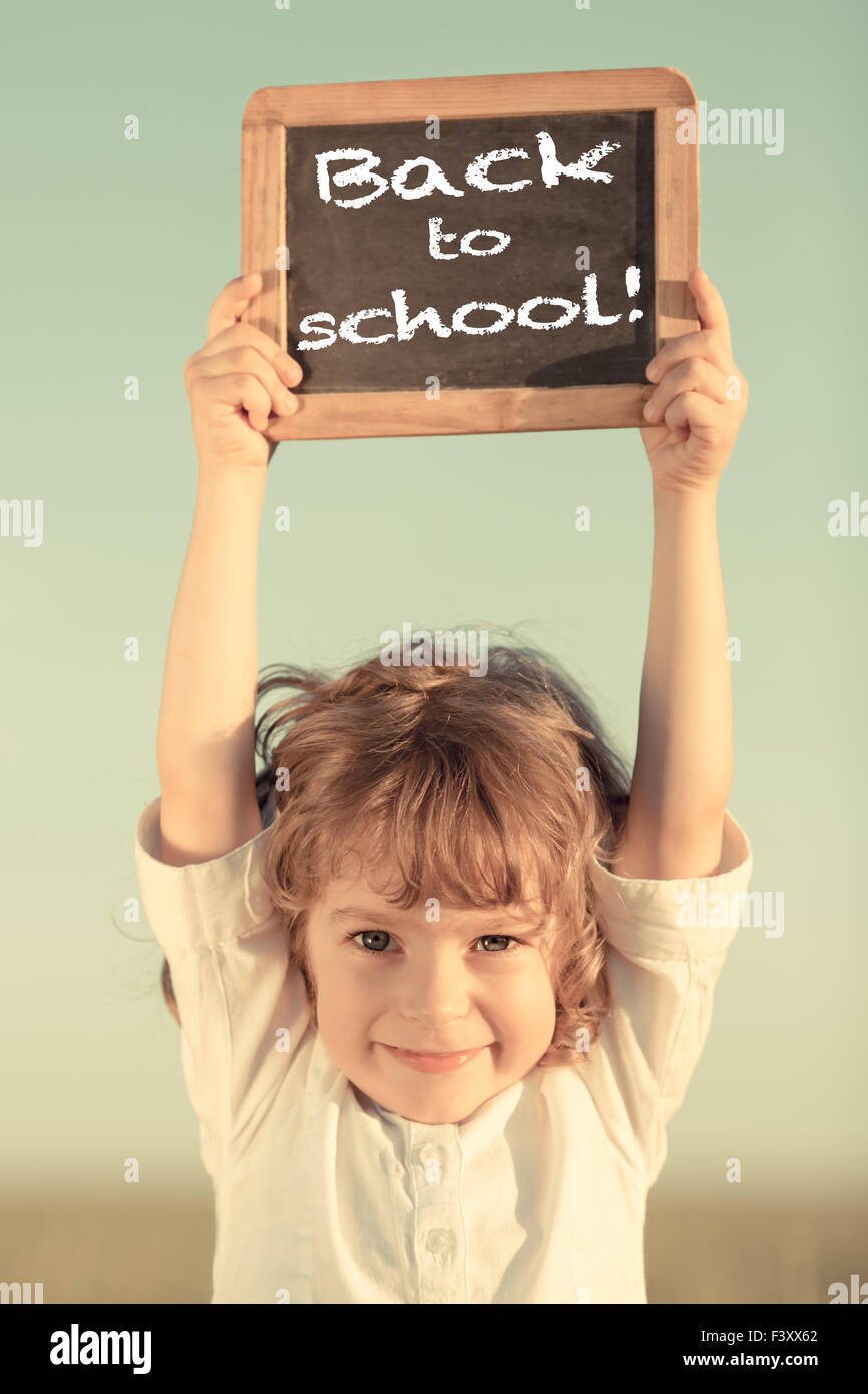 Schoolchild holding small blackboard Stock Photo