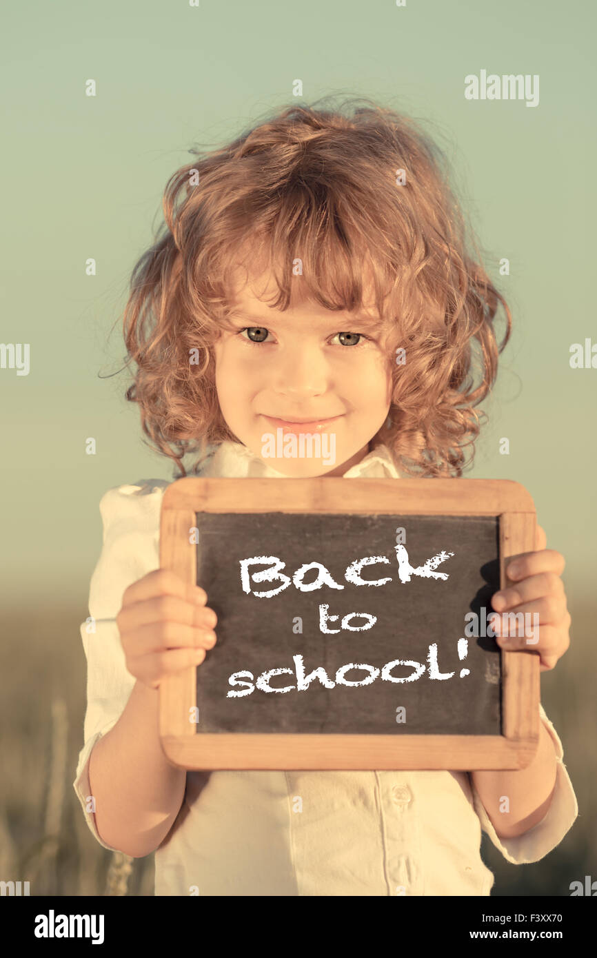 Schoolchild holding small blackboard Stock Photo