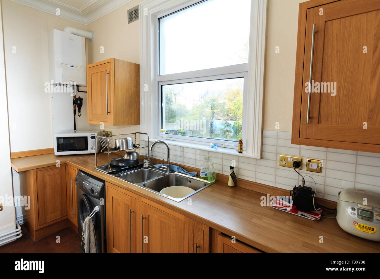 Newly decorated kitchen. Wooden cabinates, laminated worktop, white