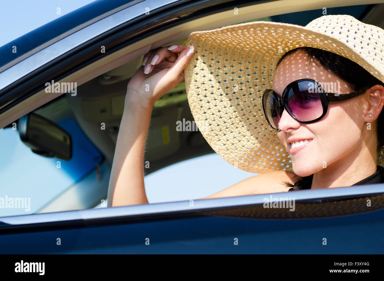 Beautiful woman sitting in a car Stock Photo