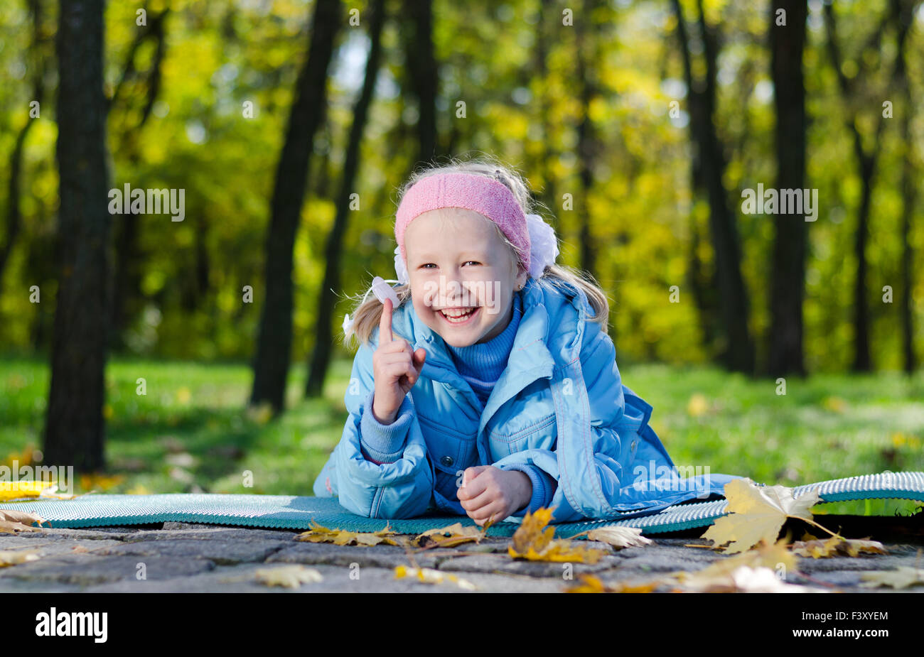 Happy little girl in an autumn park Stock Photo - Alamy
