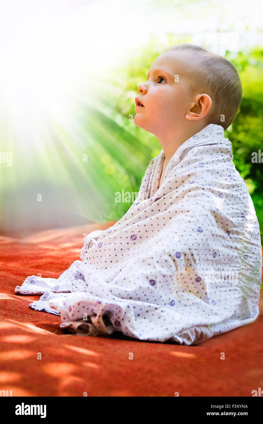 Young child looking in awe at the sun Stock Photo