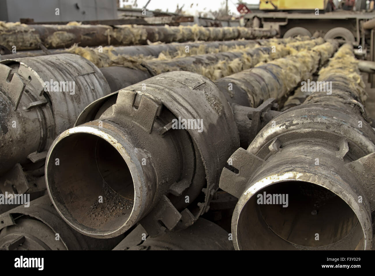 Old metal pipes are cleaned from glass wool Stock Photo Alamy