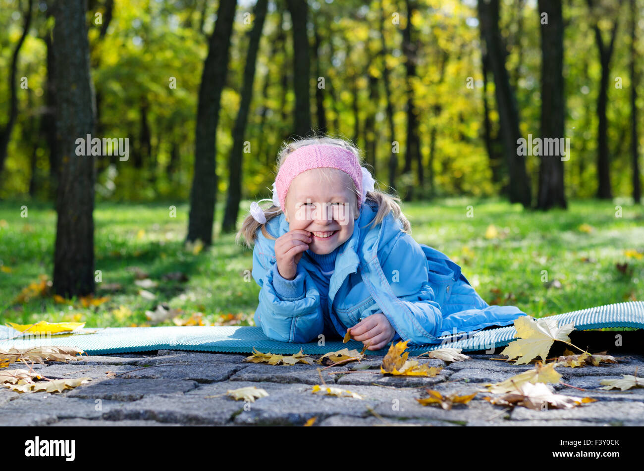 Happy little girl outdoors in the park Stock Photo - Alamy