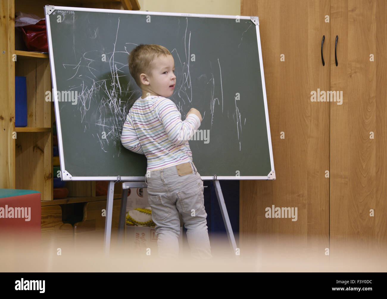 Creative little boy drawing on a chalkboard Stock Photo