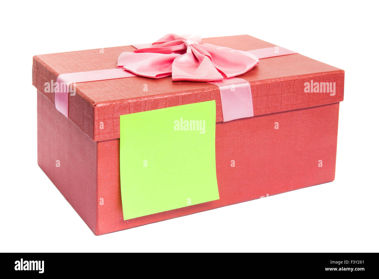Red Gift Wrapping Ribbon Around A Box With A Yellow Tag Stock