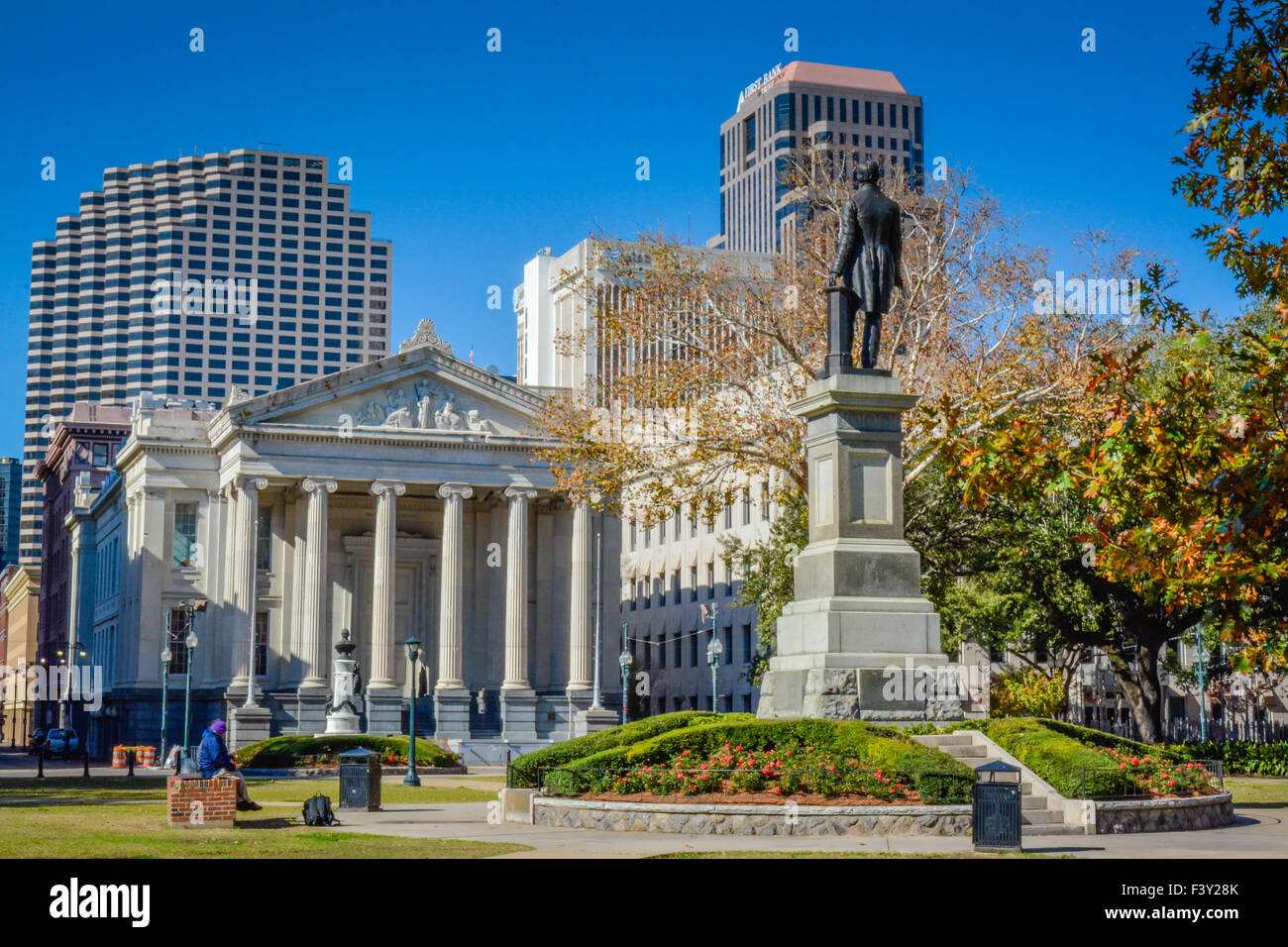 Statue of Henry Clay with Gallier Hall in the background in Lafayette Square Park in New Orleans, LA Stock Photo