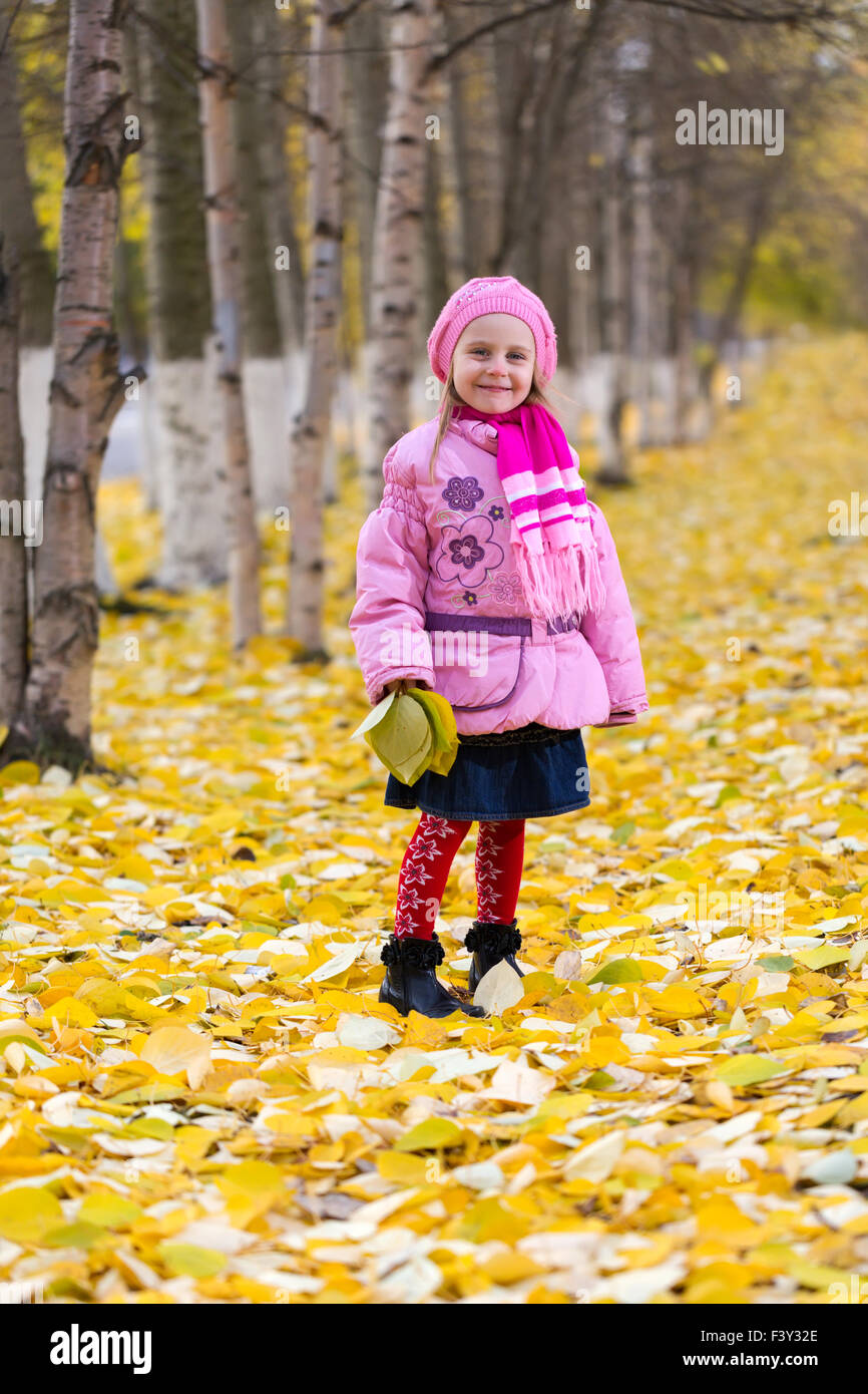 Little girl outdoors in autumn park Stock Photo - Alamy
