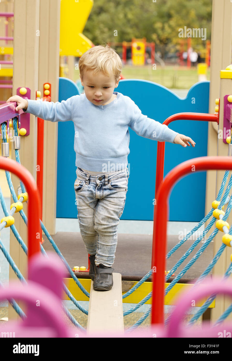 Cute little boy playing in a playground Stock Photo - Alamy