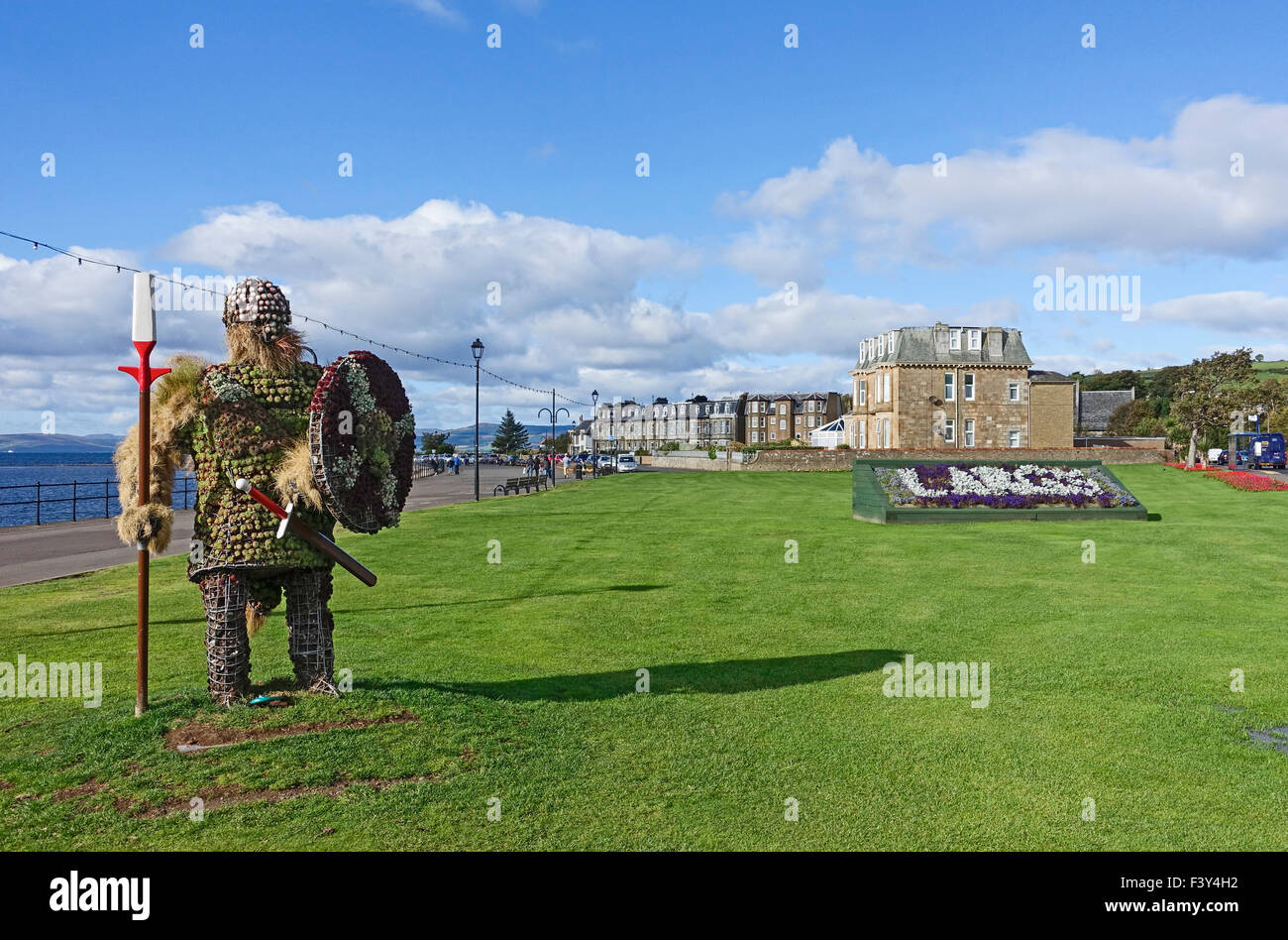 Statue of "Magnus the Viking" made from flowers standing at the