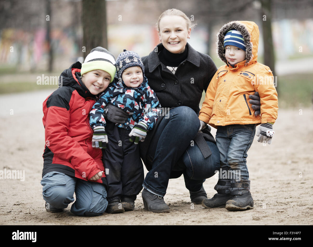 Happy mother with her three young children Stock Photo