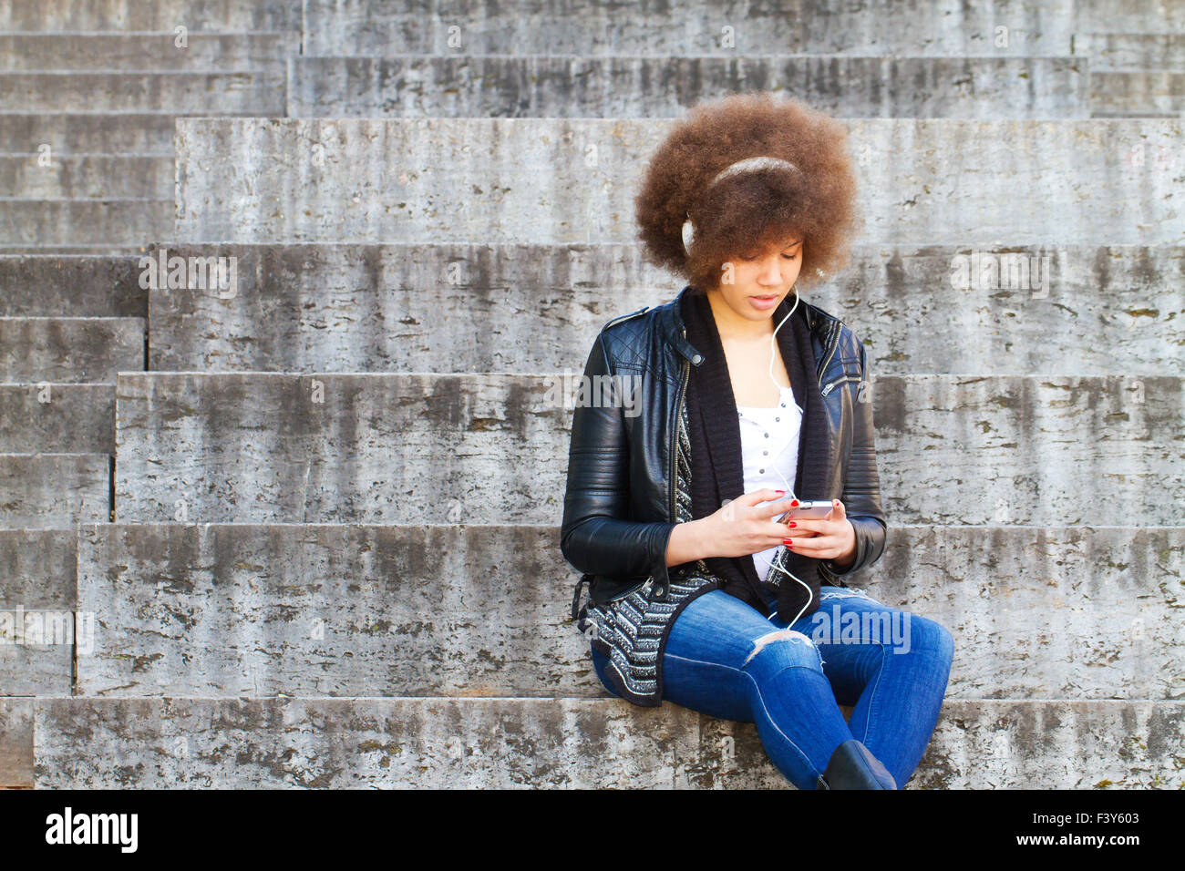 Young, black woman listening music Stock Photo