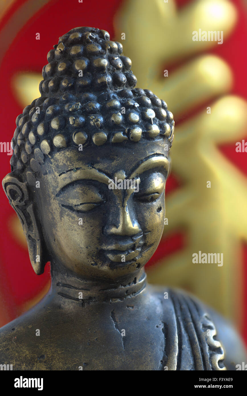 Buddha head, Chinese characters behind Stock Photo