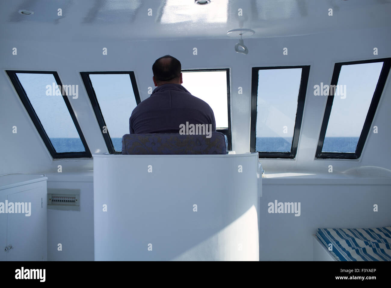 Man navigating a boat Stock Photo