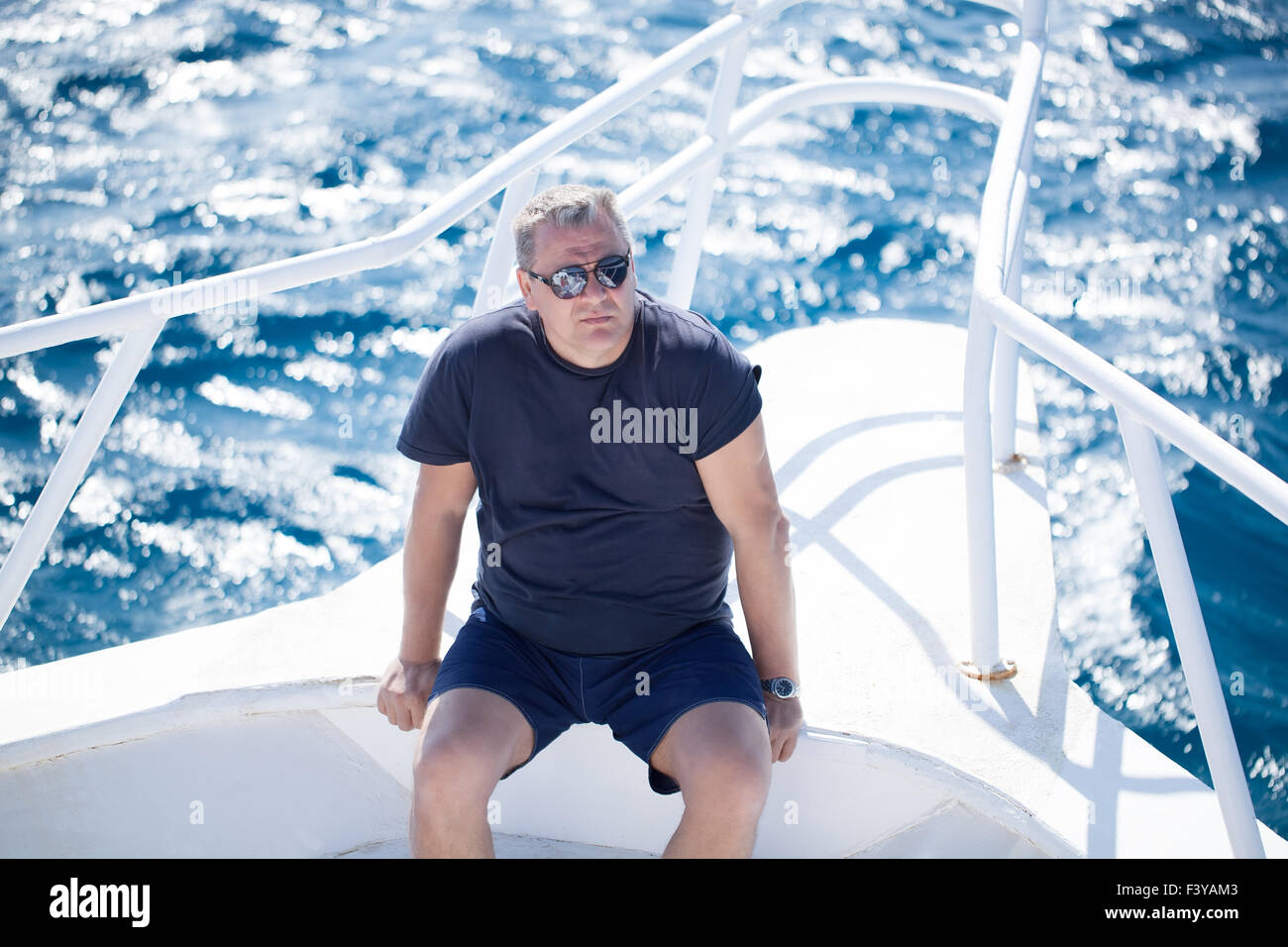 Man sitting on a boat hi-res stock photography and images - Alamy