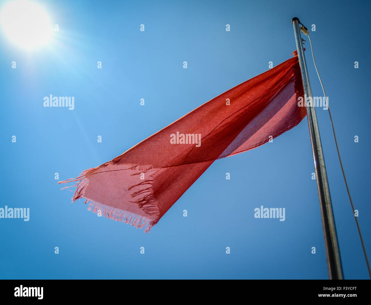 Flag red beach sea wind hires stock photography and images Alamy
