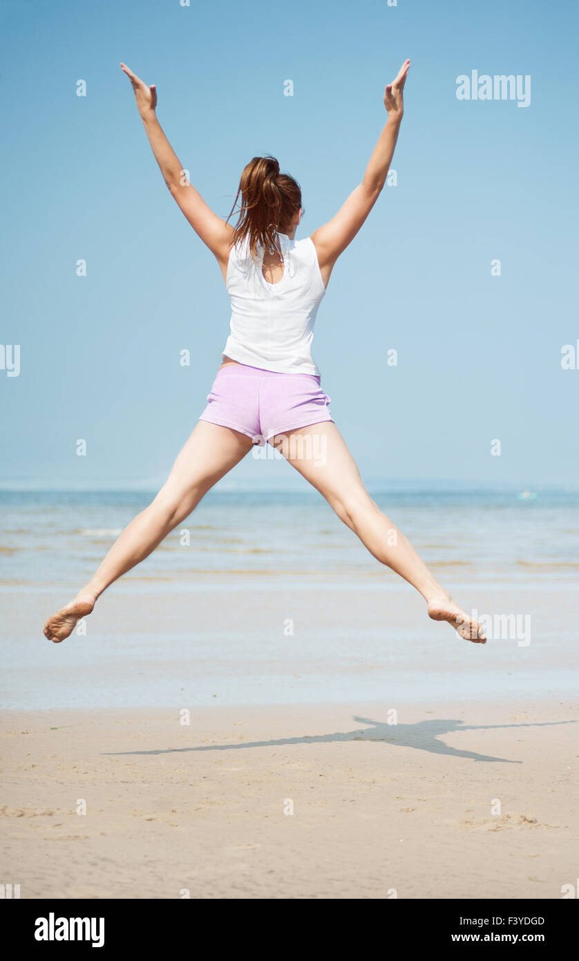 Woman jumping on the beach Stock Photo Alamy