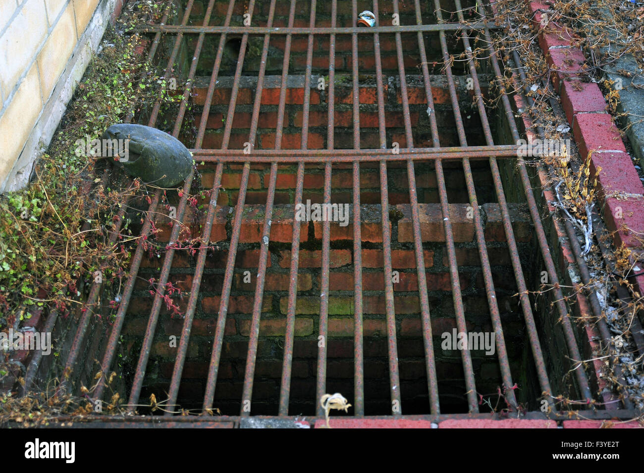Metal bars covering a brick lined drain in the town of Bath in Somerset. Stock Photo