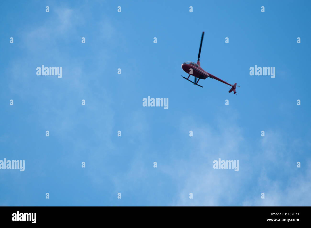 Helicopter high above on blue sky Stock Photo