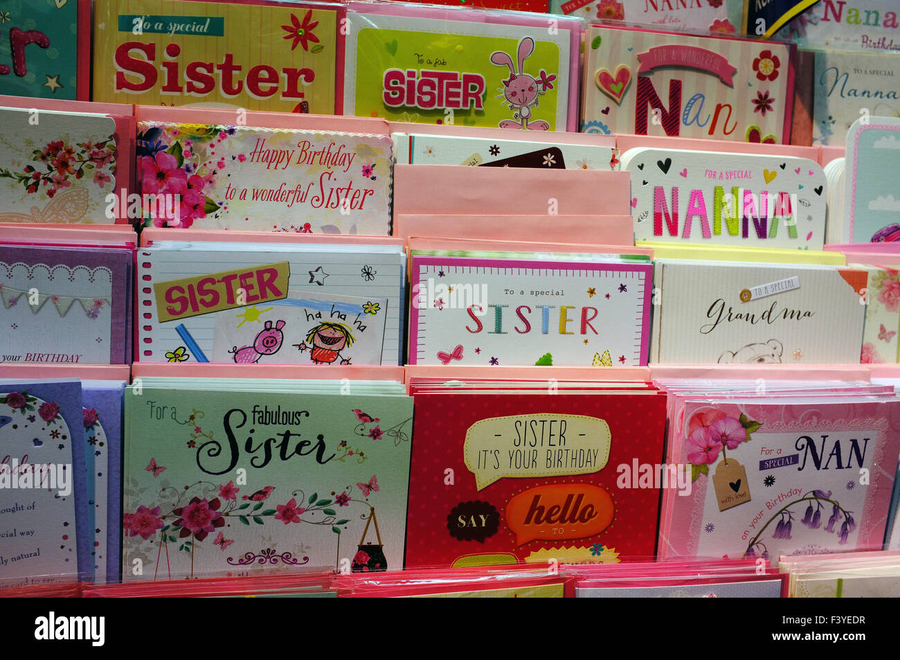 A display of stereotypically feminine birthday cards for Sisters and Nans in a card shop. Stock Photo