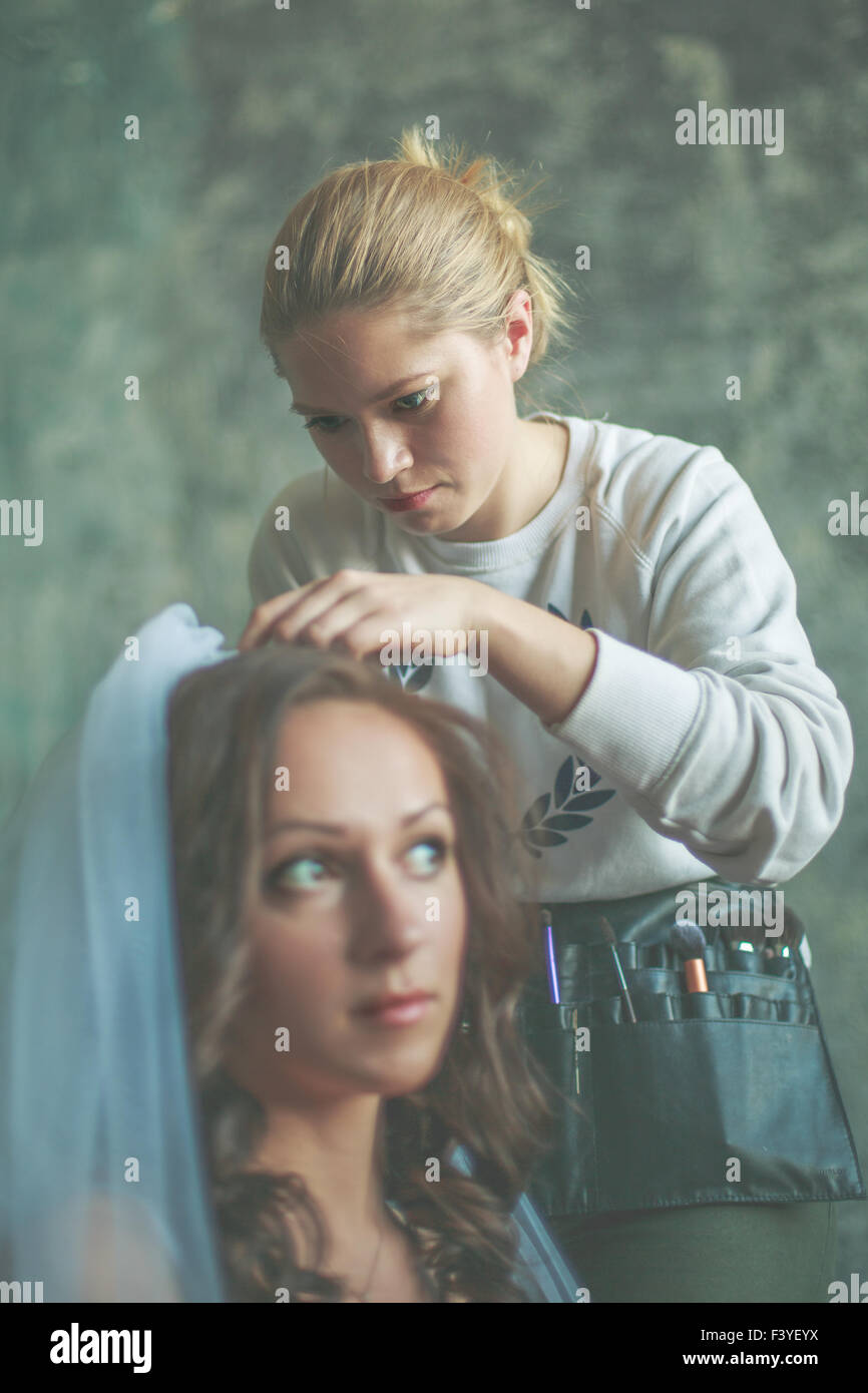 Hair stylist makes the bride Stock Photo