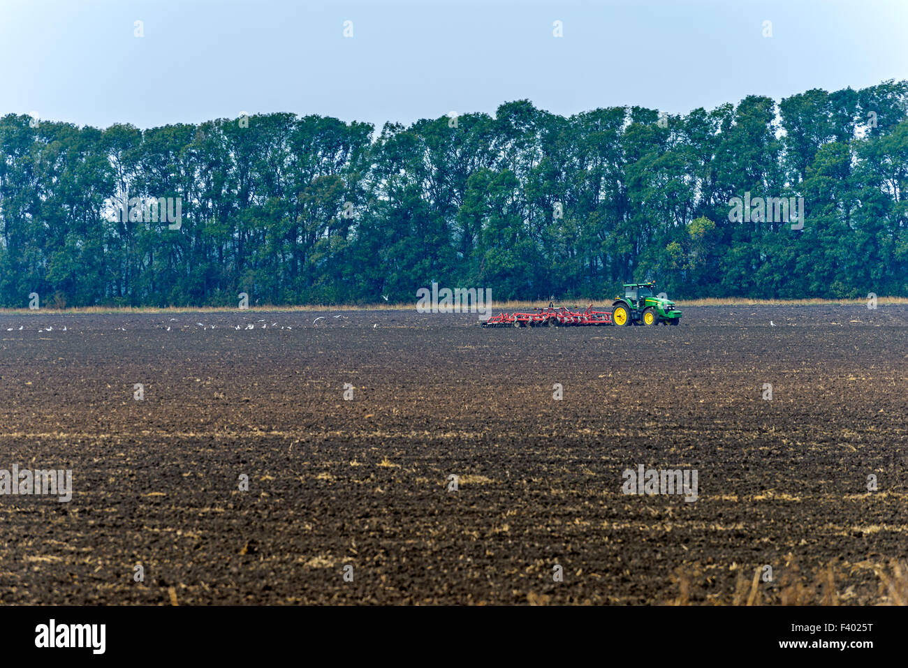 Tractor plowing the land Stock Photo - Alamy