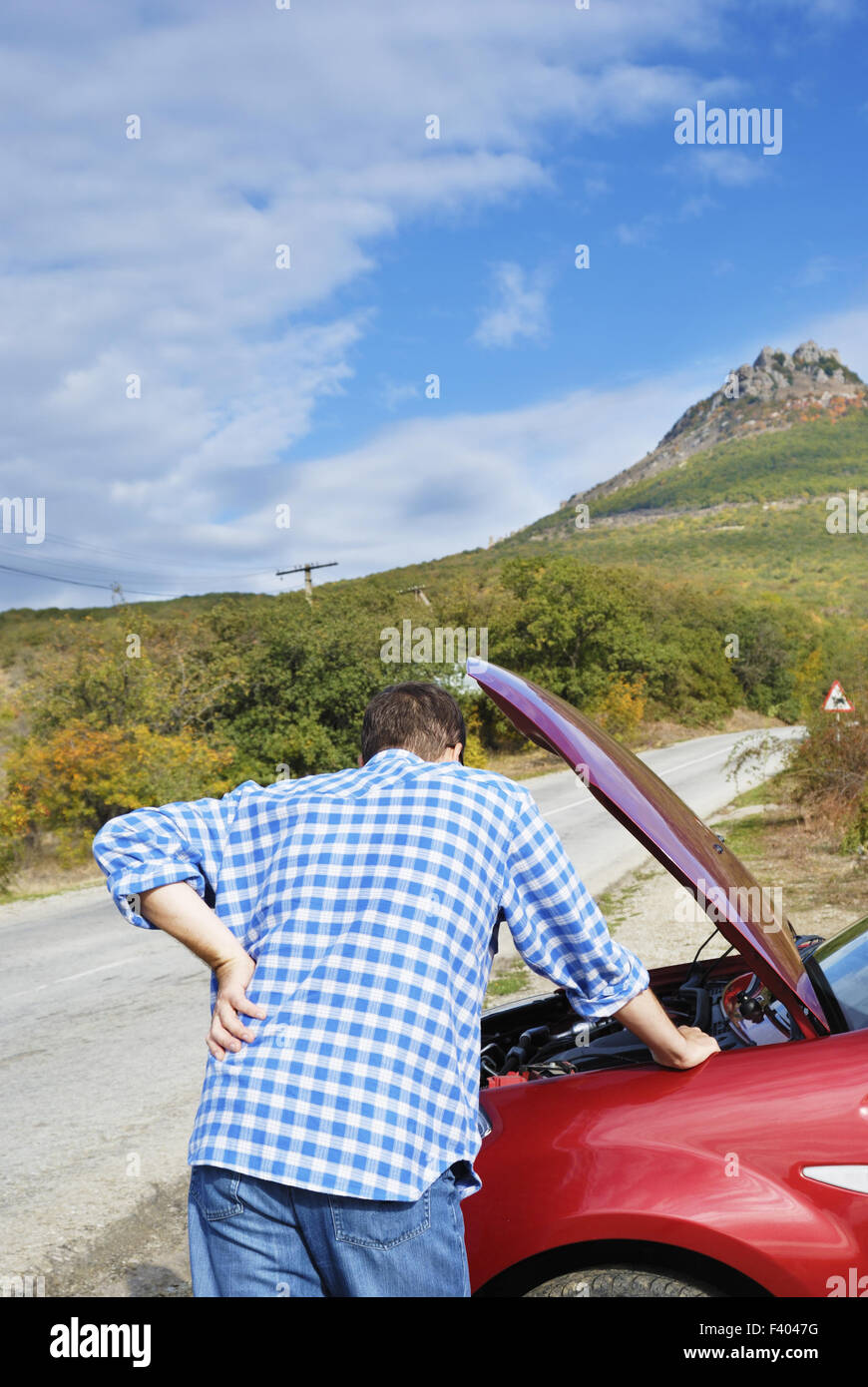 Adult man is standing near his broken car Stock Photo