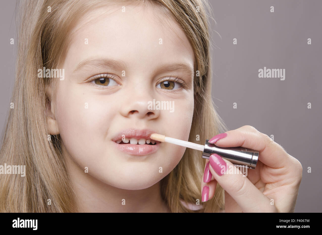 Makeup artist deals Shine on the lips girls Stock Photo