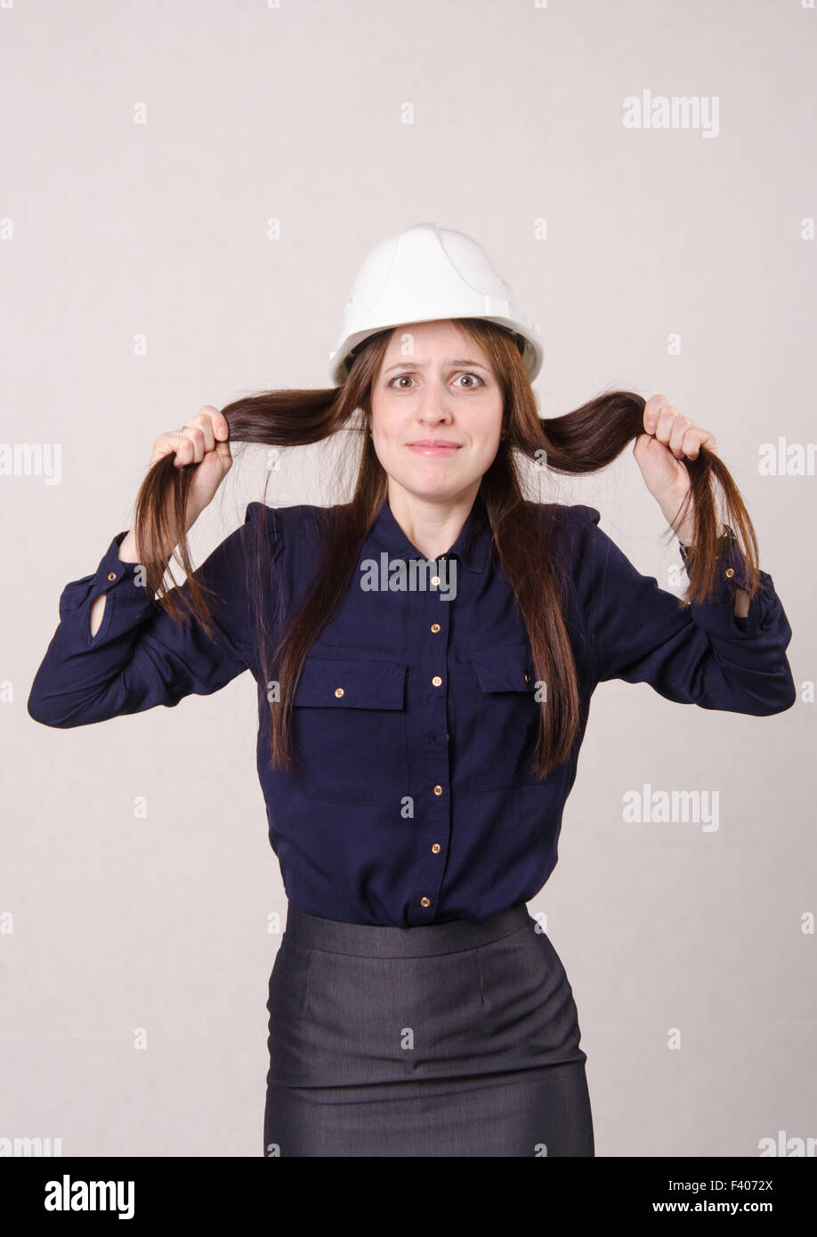 Young girl in shock clutching her hair Stock Photo