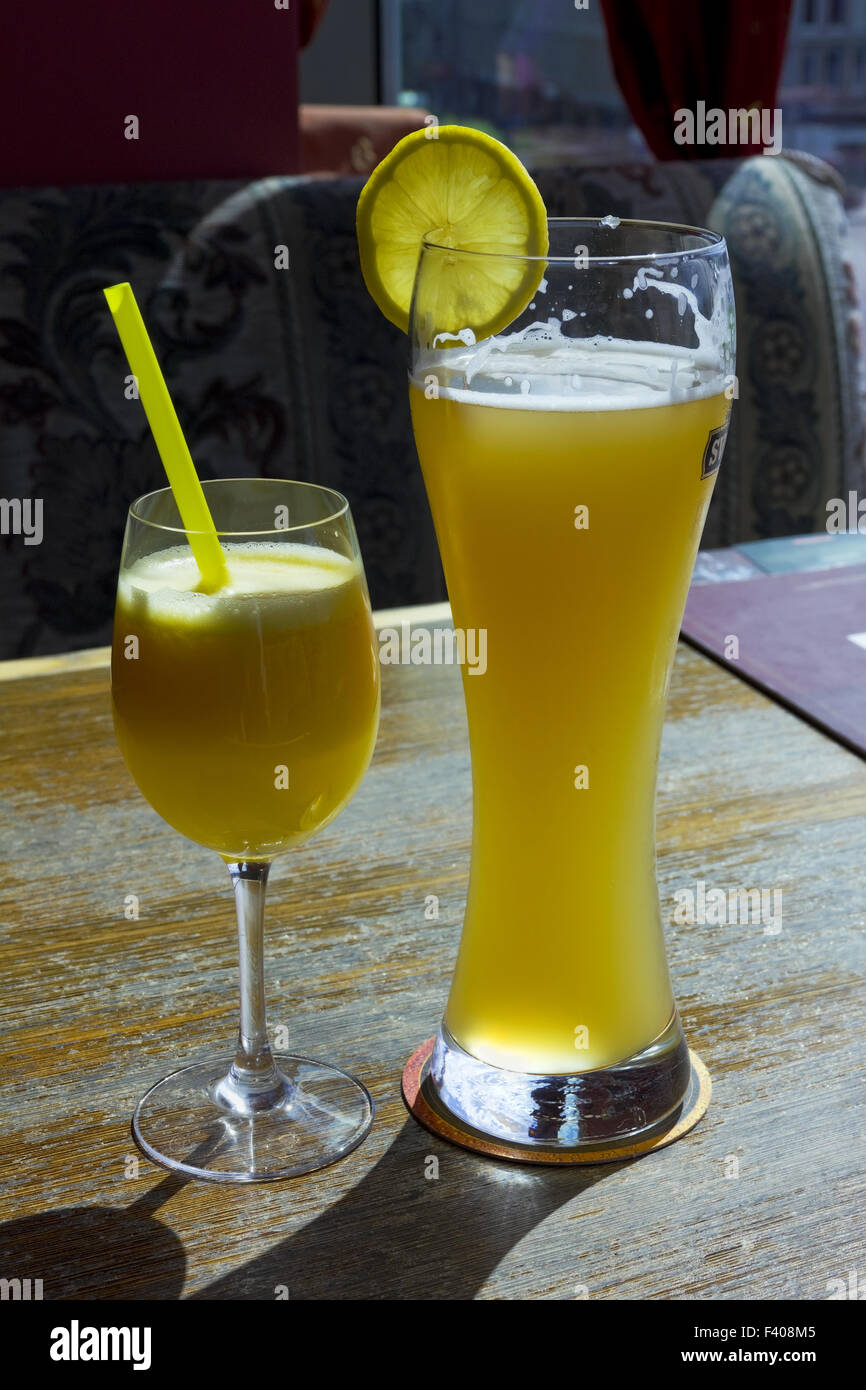 Yellow orange juice and beer Stock Photo Alamy