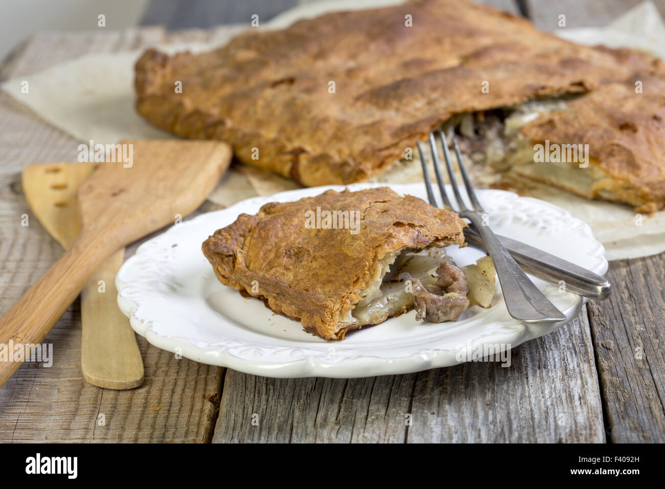Pie with meat and potatoes on the plate. Stock Photo