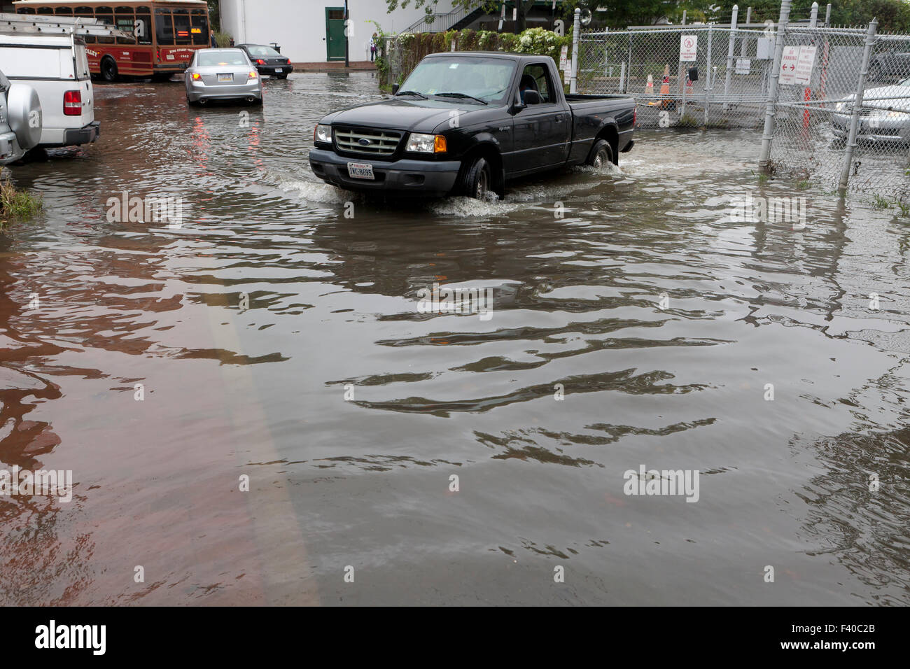 Car driving through flooded street - Alexandria, Virginia USA Stock Photo