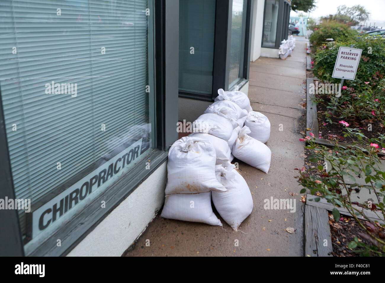 Sandbags placed at business building entrance in preparation for flooding - Alexandria, Virginia USA Stock Photo