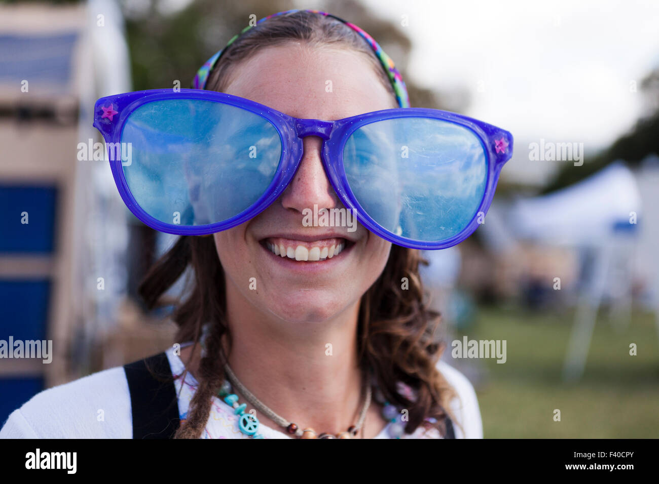 Woman wearing over-sized novelty sunglasses - USA Stock Photo