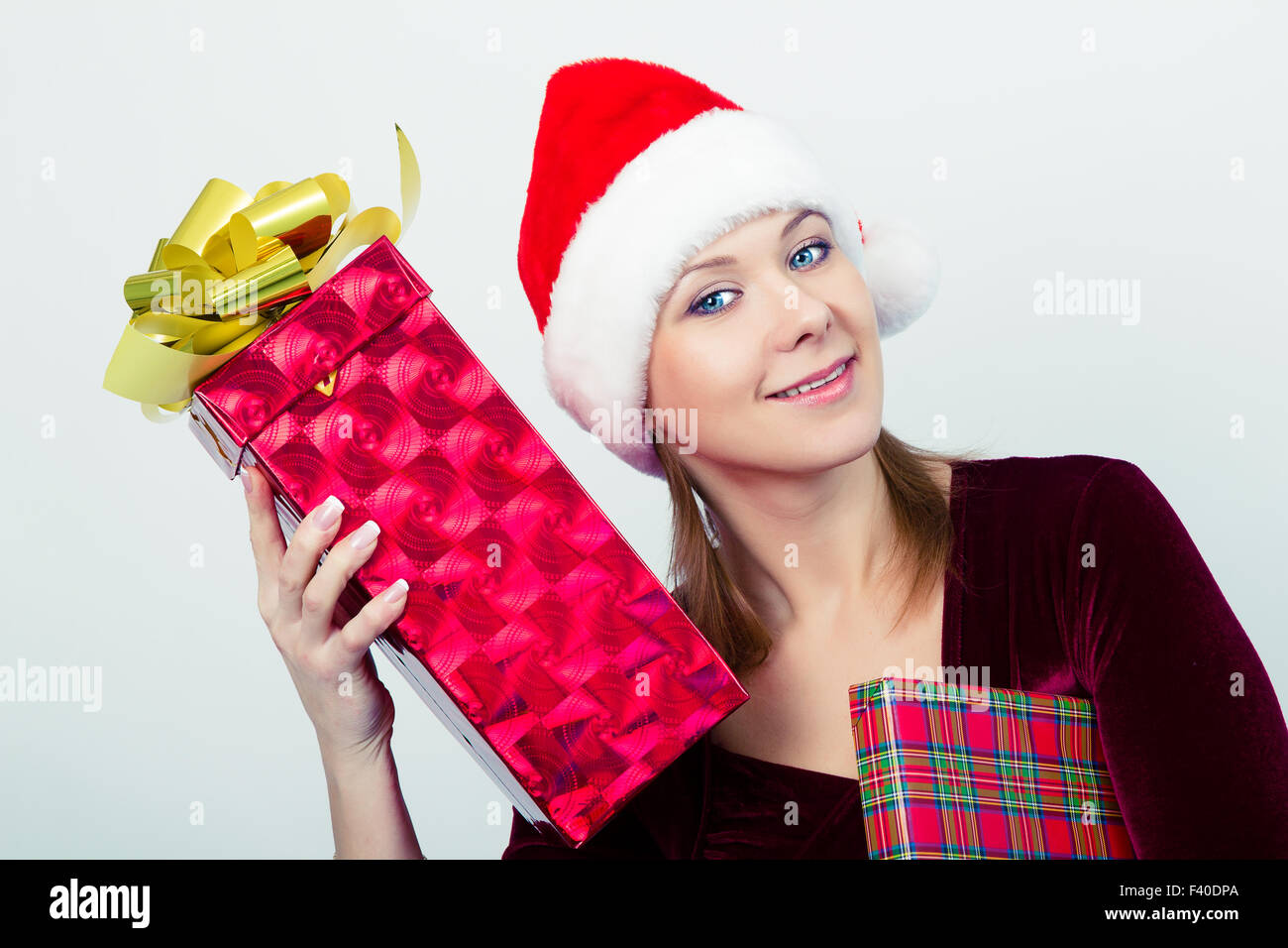 happy girl in santa hat with gift boxes Stock Photo - Alamy